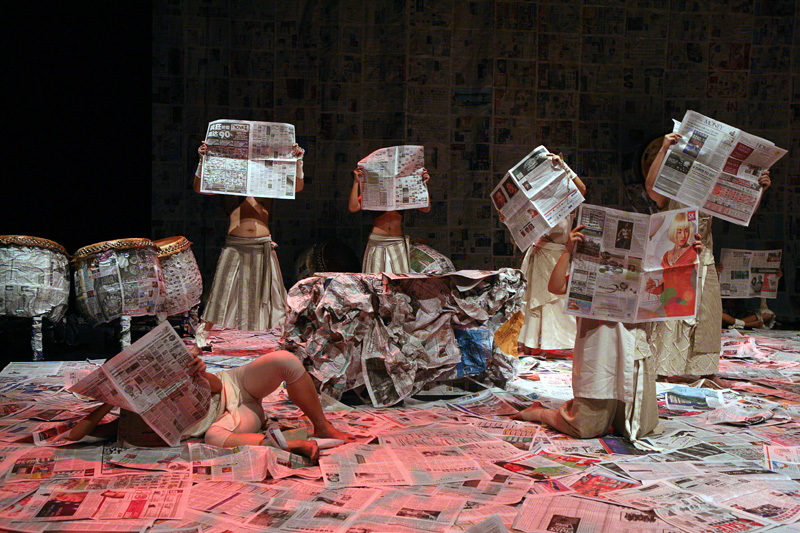 People in different poses holding newspapers in Death of A Hero by Paper Monkey Theatre Singapore