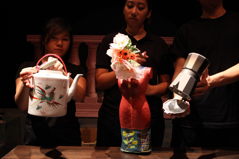 A nonya puppet, a old water flask and moka in The Nonya Nightingale by Paper Monkey Theatre Singapore