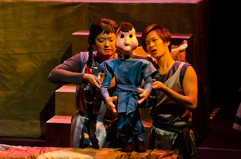 Boy puppet manipulated by two actors Dragon Dance by Paper Monkey Theatre Singapore