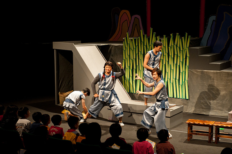 Four actors on stage in different poses Dragon Dance by Paper Monkey Theatre Singapore