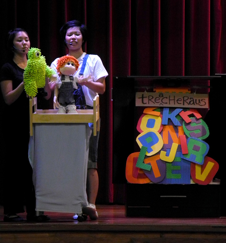 Joey puppet and green monster puppet learning spelling in Monster Under My Bed Community Tour