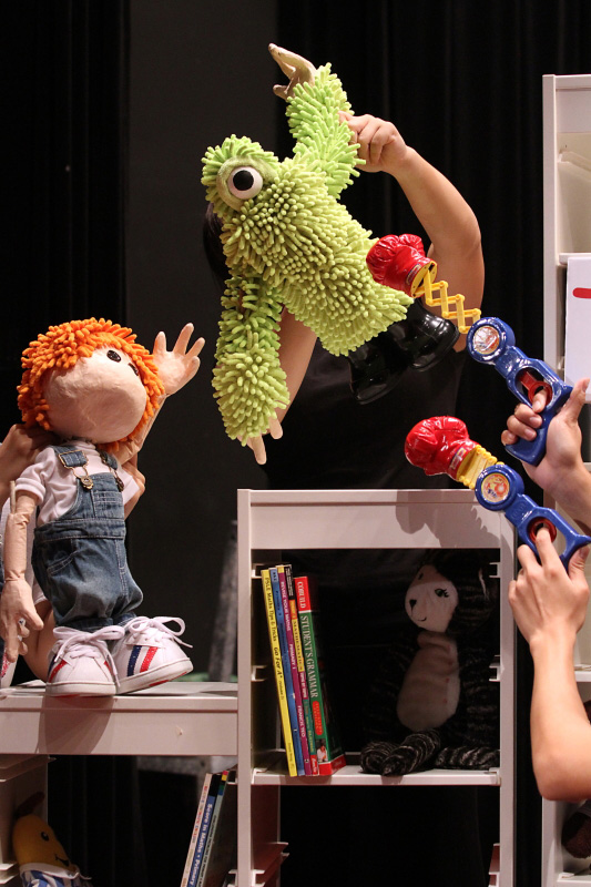 Joey puppet playing with green monster jumping in the air in Monster Under My Bed by Paper Monkey