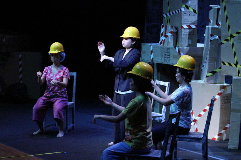 People with safety helmets with three seated and one standing up in Paper Monkey Mercury