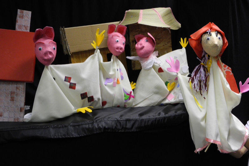 Three pig puppets and one girl puppet in go Bananas workshop
