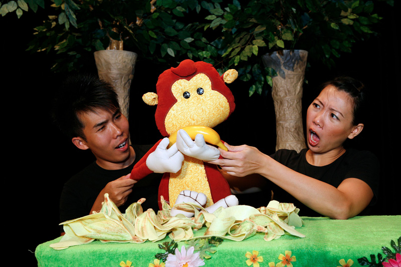 Monkey puppet eating banana in Tree Neighbours by Paper Monkey Theatre Singapore