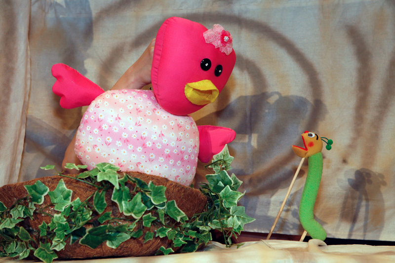 The pink duck puppet talking to green worm puppet in Tree Neighbours by Paper Monkey Theatre Singapore
