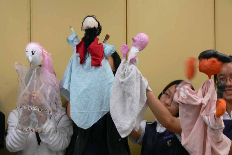 Students holding up the puppets they made in Go Bananas Workshop