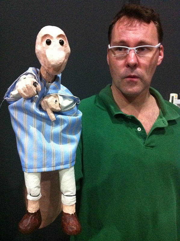 A caucasian adult student holding up a puppet