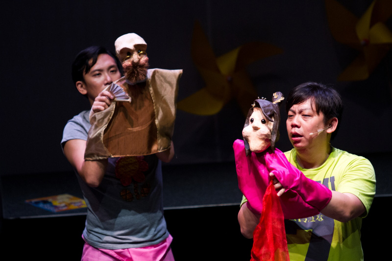 A lady and an old man hand puppets held by two actors in The Three Big Bullies by Paper Monkey Theatre Singapore