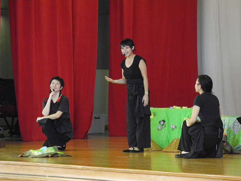 Actor talking to audience on stage in Dragon Dance Community Tour by Paper Monkey