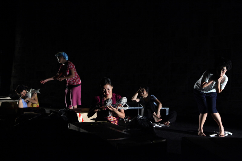 Five actresses on stage in a dark setting all looking in distress in Paper Monkey Mercury